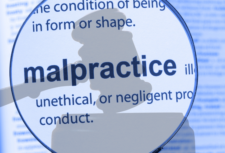 Magnifying glass over the definition of "malpractice." Shadow of a gavel overlayed.