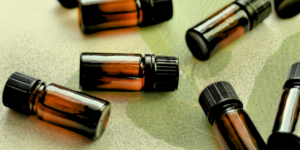 Small brown tincture bottles on a background of leaves.