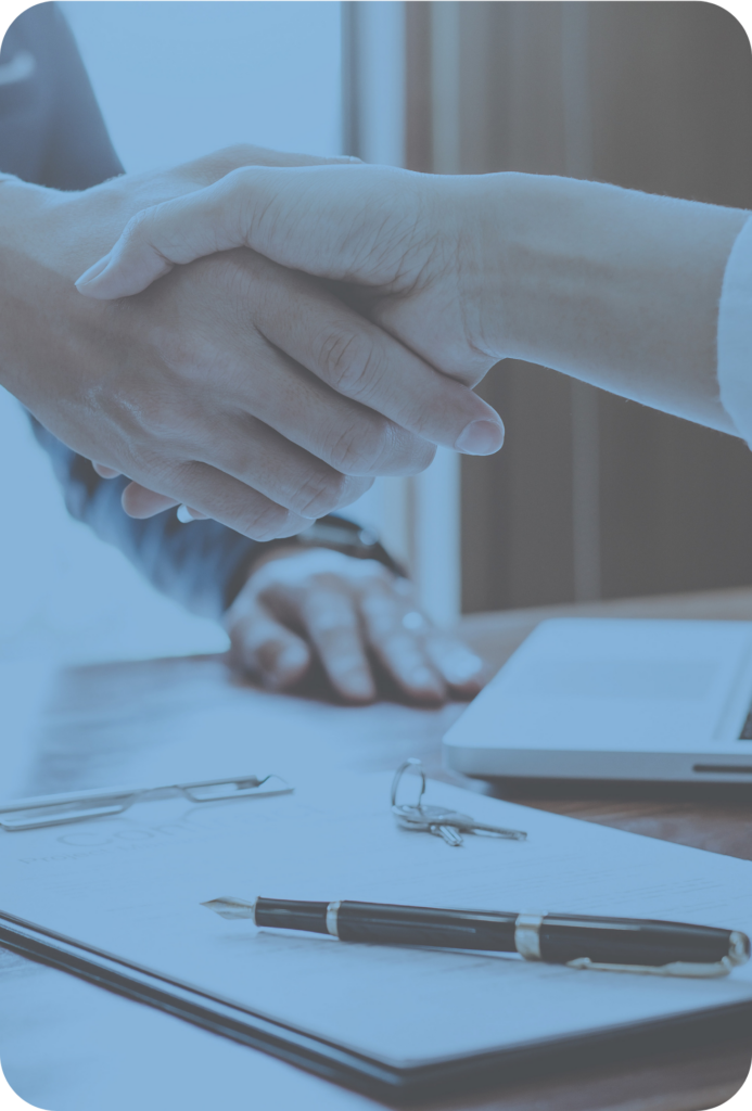 Shaking hands over documents.